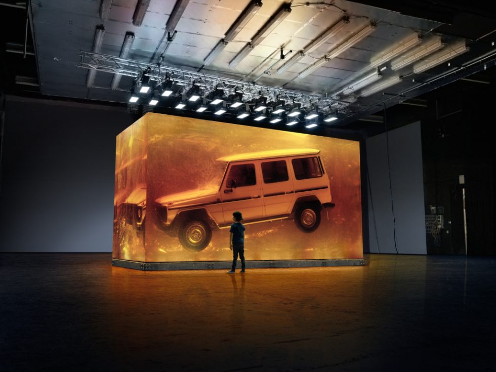 Making Of: Snapshot with a young viewer during the photo production. With the world's largest installation made of synthetic resin, Mercedes-Benz will focus on the world premiere of the new G-Class on 14 January 2018 at the North American International Auto Show (NAIAS) in Detroit. Copyright Daimler AG, photo by: Hans Starck